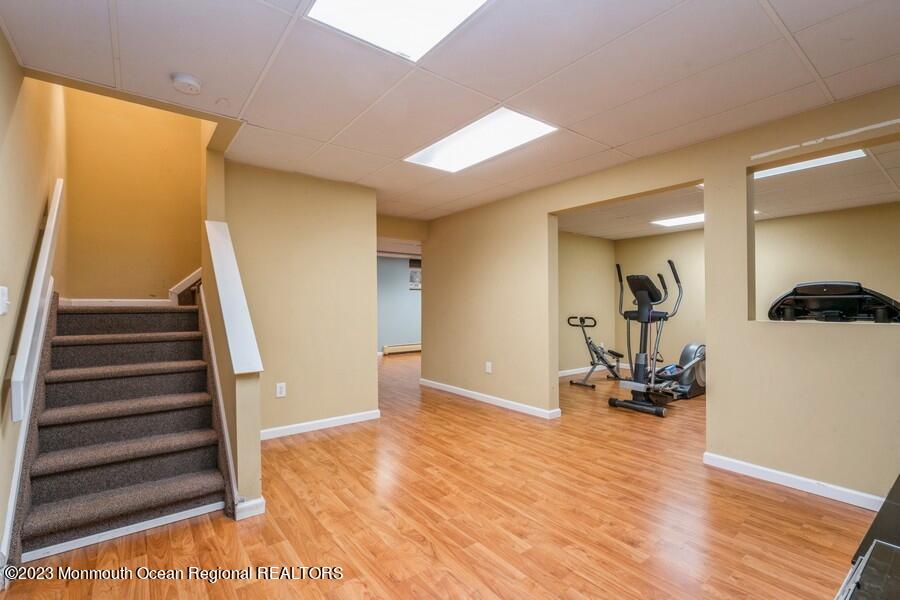 30 Chagall Road Marlboro, NJ 07746 - Photo 22 of 26 a view of an empty room with wooden floor and stairs