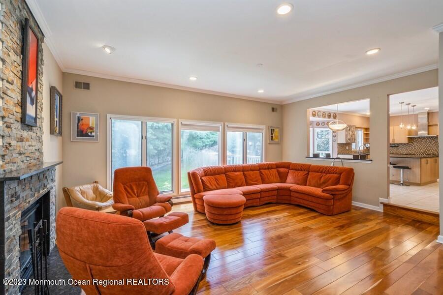 30 Chagall Road Marlboro, NJ 07746 - Photo 9 of 26 a living room with fireplace furniture and a floor to ceiling window