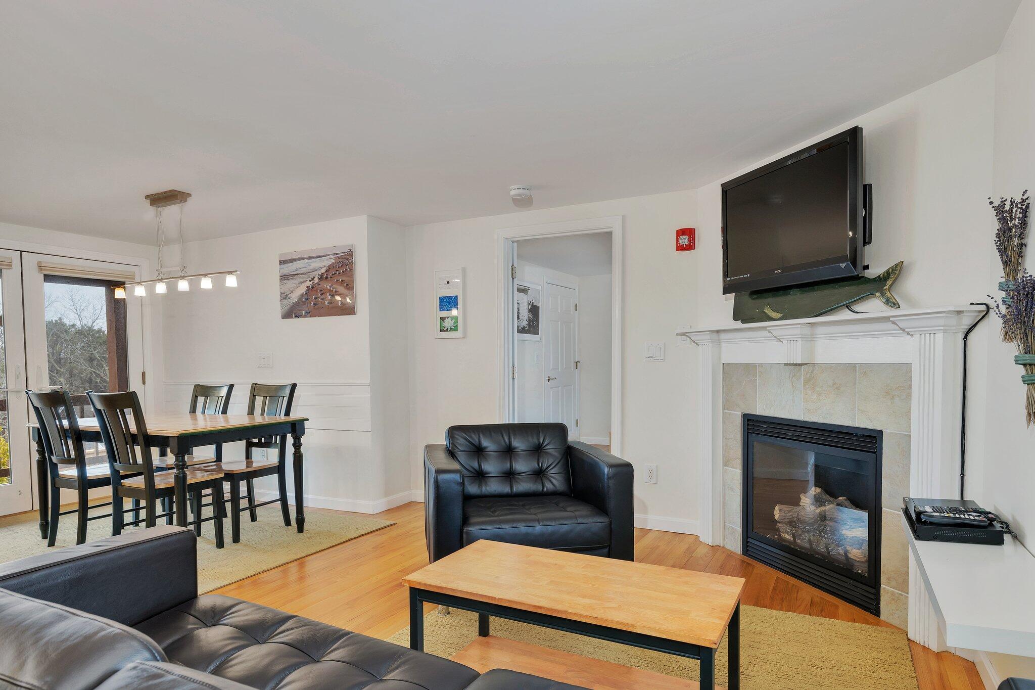 6 Shore Road, Unit 26 Truro, MA 02666 - Photo 12 of 25 a living room with furniture a flat screen tv and a fireplace