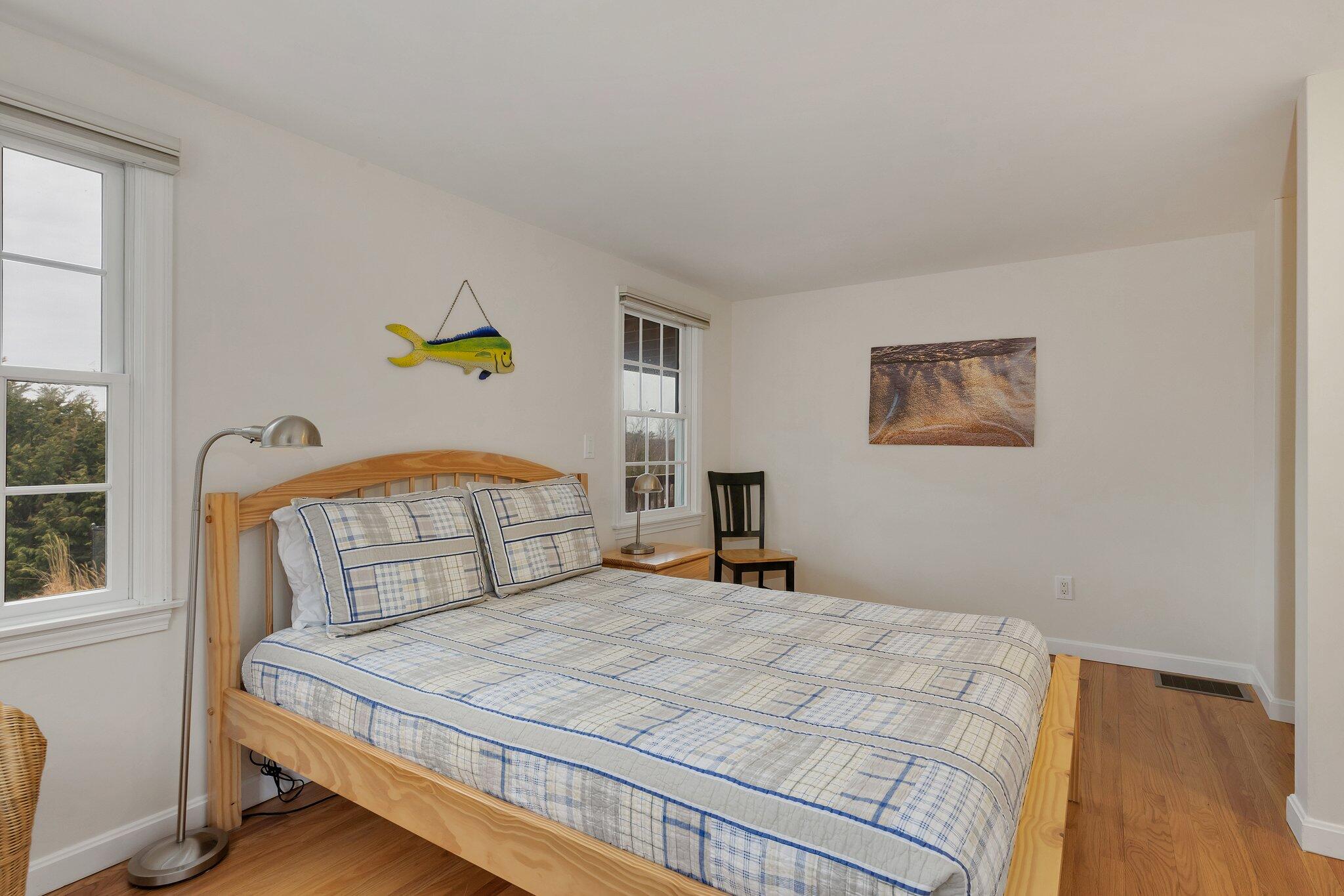 6 Shore Road, Unit 26 Truro, MA 02666 - Photo 16 of 25 a bedroom with a bed a painting on the wall and a window