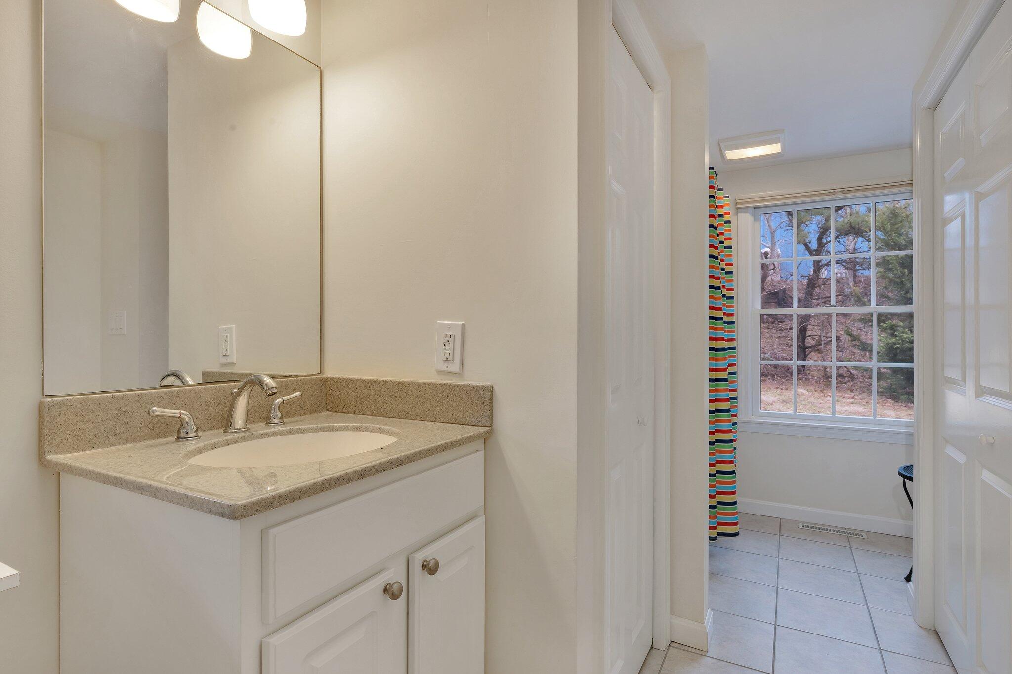 6 Shore Road, Unit 26 Truro, MA 02666 - Photo 18 of 25 a bathroom with a sink and a mirror