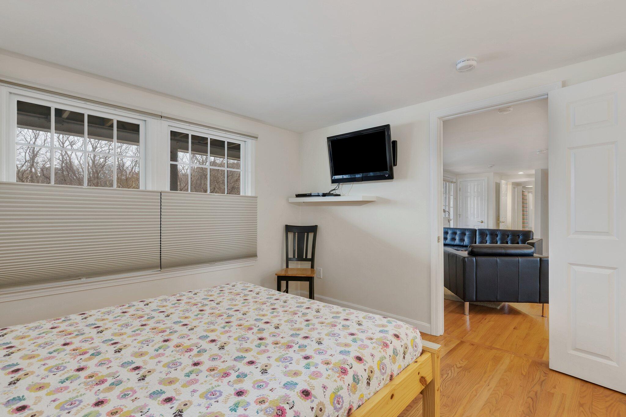 6 Shore Road, Unit 26 Truro, MA 02666 - Photo 19 of 25 a bedroom with a bed and a flat screen tv