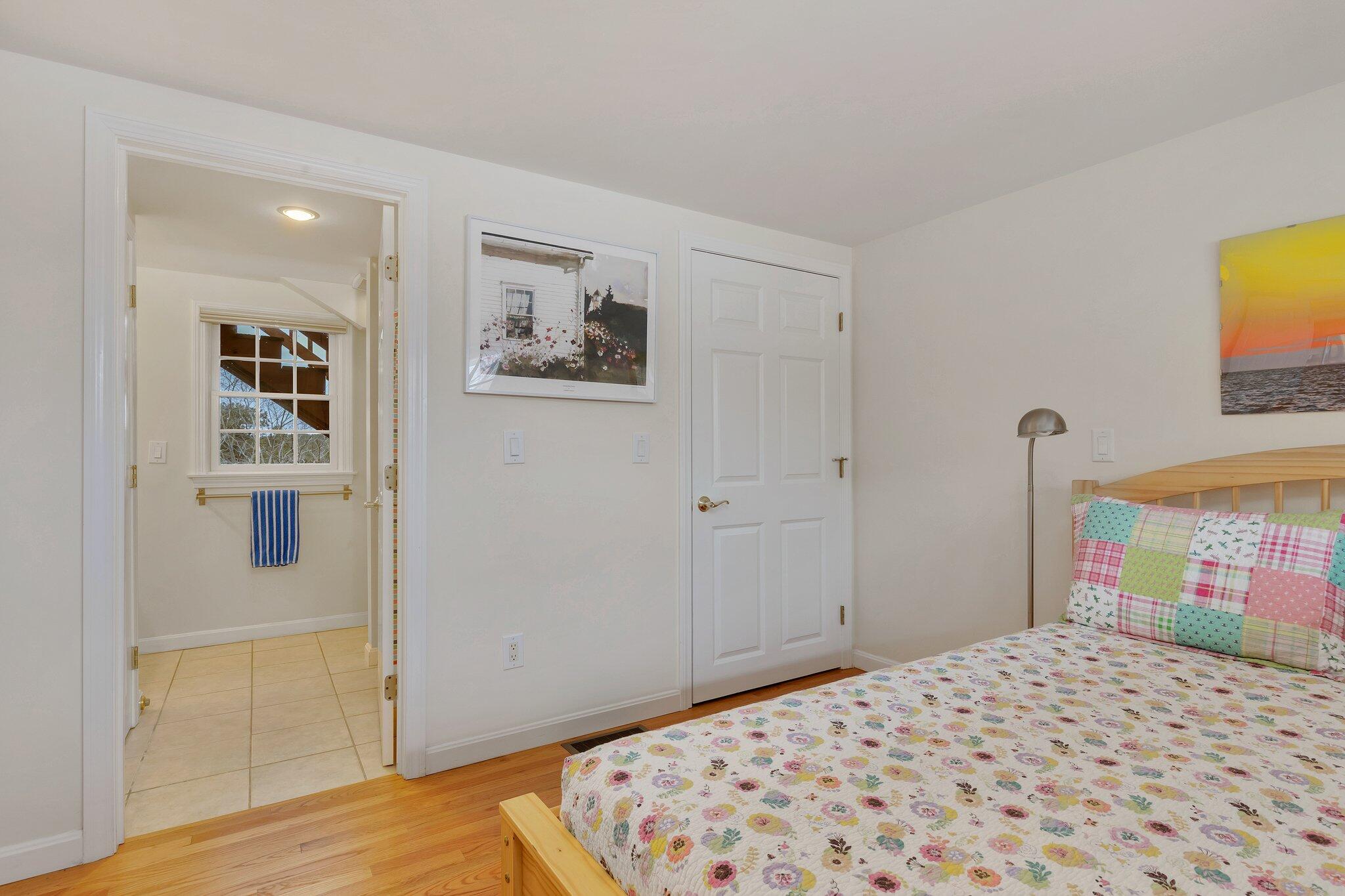 6 Shore Road, Unit 26 Truro, MA 02666 - Photo 20 of 25 a bedroom with a bed and a painting on the wall