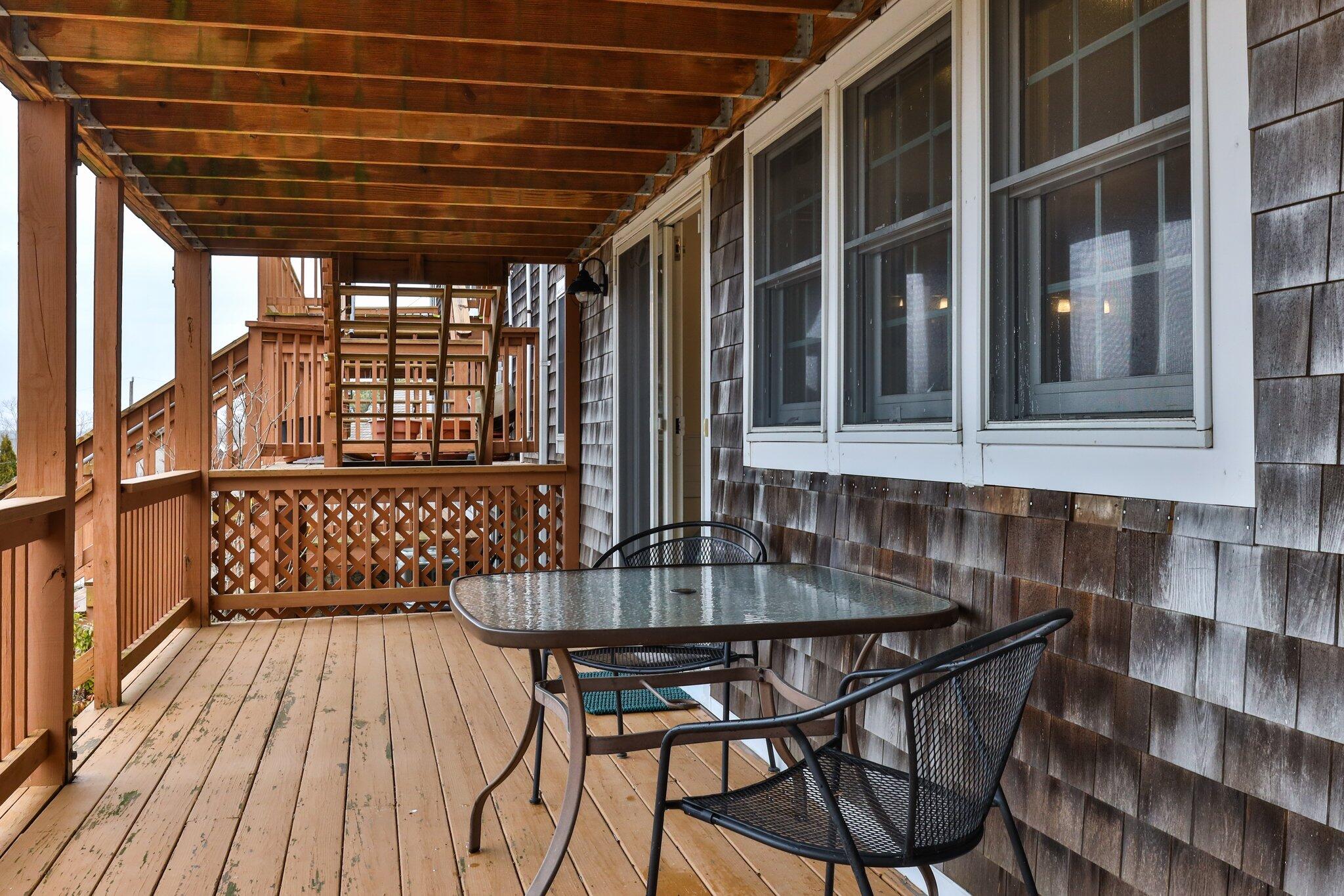 6 Shore Road, Unit 26 Truro, MA 02666 - Photo 23 of 25 a view of a chairs and table in the patio