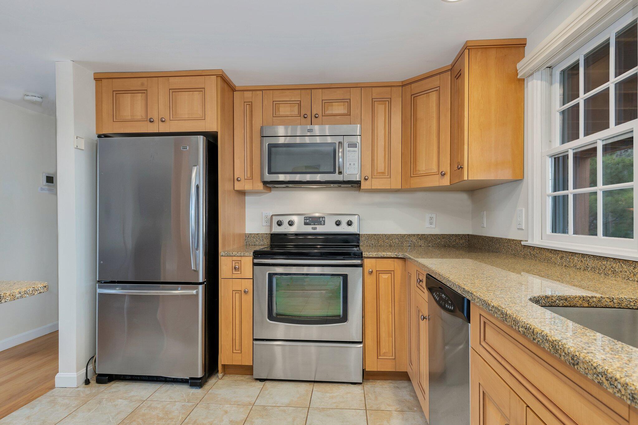 6 Shore Road, Unit 26 Truro, MA 02666 - Photo 4 of 25 a kitchen with granite countertop stainless steel appliances and granite counter tops