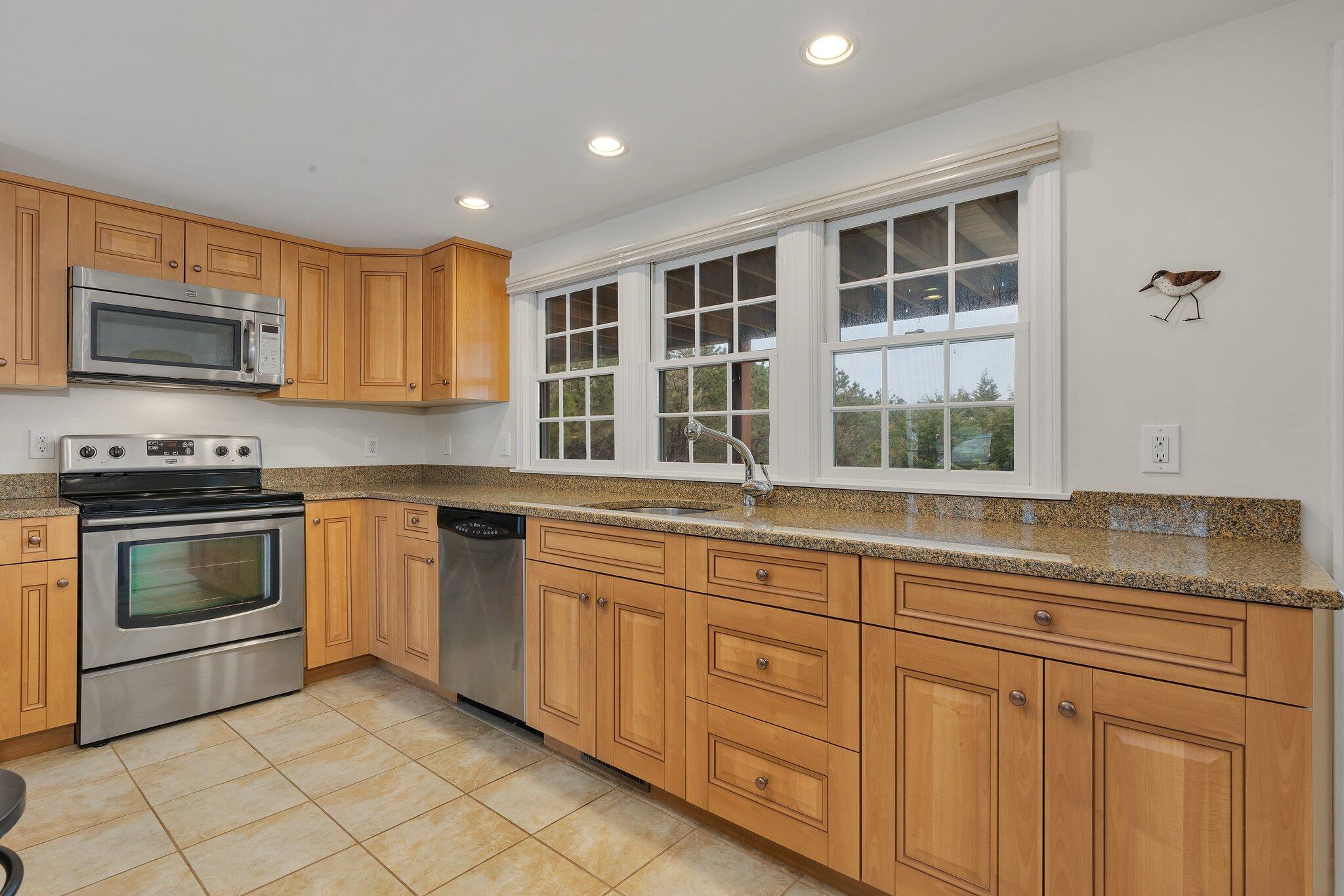6 Shore Road, Unit 26 Truro, MA 02666 - Photo 6 of 25 a kitchen with granite countertop cabinets stainless steel appliances and a sink