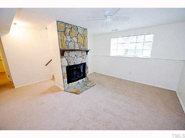 8020 Mourning Dove Road Raleigh, NC 27615 - Photo 5 of 12 a view of an empty room with a fireplace and a window