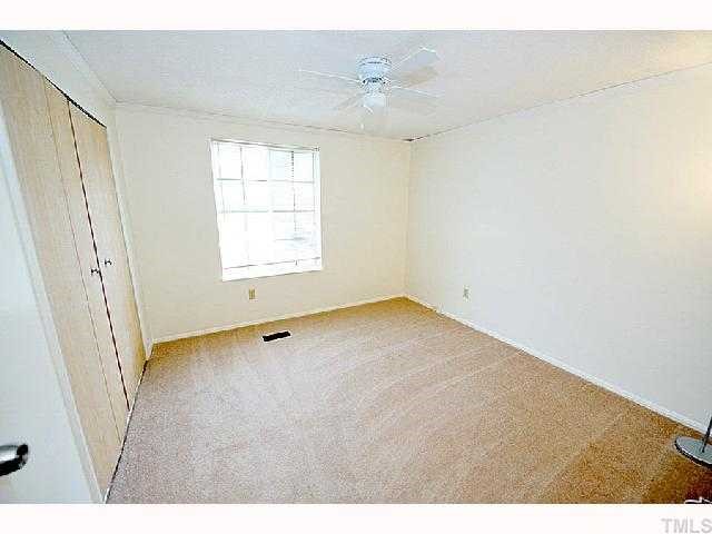 8020 Mourning Dove Road Raleigh, NC 27615 - Photo 8 of 12 a view of an empty room with a window