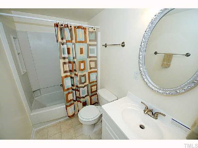 8020 Mourning Dove Road Raleigh, NC 27615 - Photo 9 of 12 a bathroom with a sink a toilet and shower