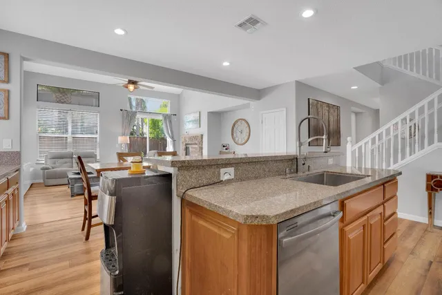 a view of living room with granite countertop furniture and a wooden floor