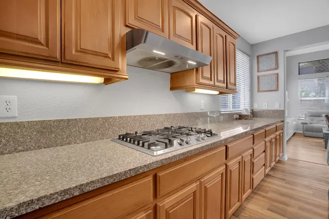 a kitchen with stainless steel appliances granite countertop a stove and a sink