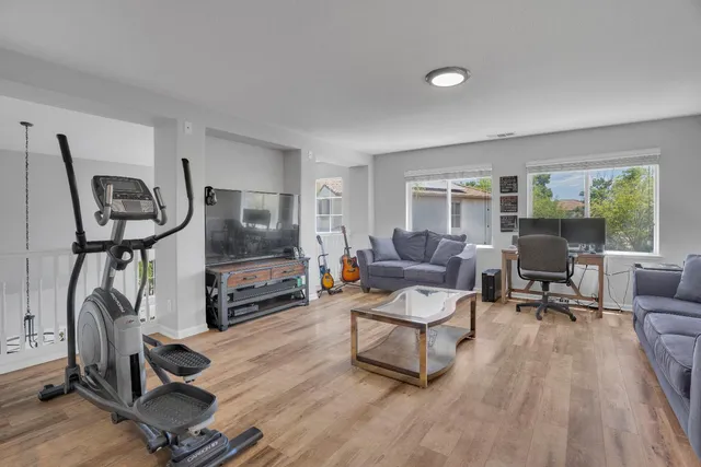 a living room with furniture or window and a wooden floor