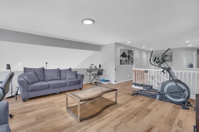 a living room with furniture a flat screen tv and a large window