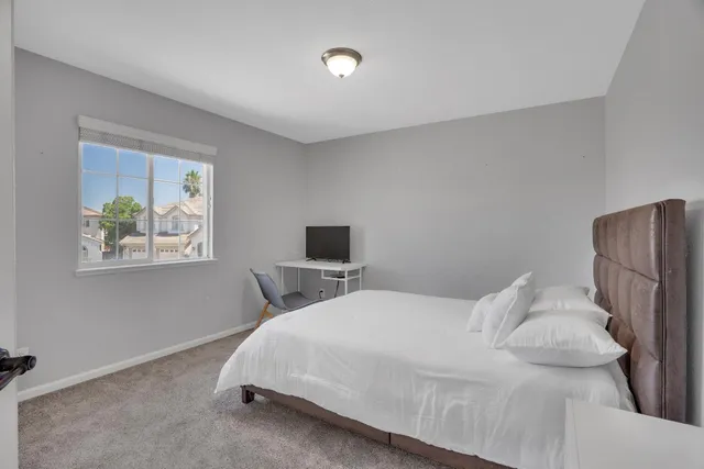 a bedroom with a bed and a window