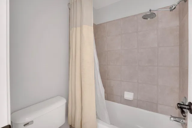 a bathroom with a shower and a toilet