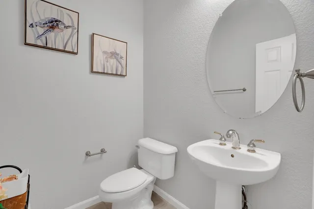 a bathroom with a sink a mirror and a toilet