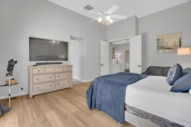 a bedroom with a bed and wooden floor