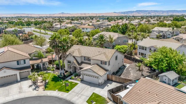 an aerial view of a house with garden space and street view