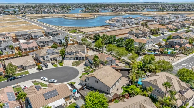 an aerial view of residential houses with outdoor space and swimming pool