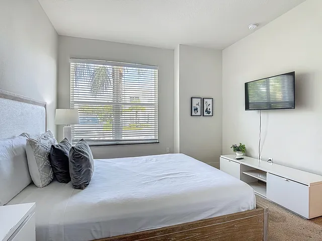 a view of hallway with furniture and a ceiling fan