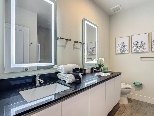 a bathroom with double sink and a mirror