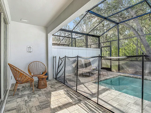 a view of a house with backyard and sitting area