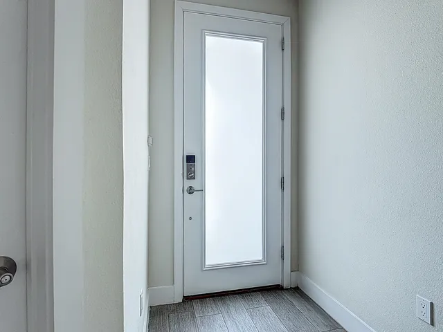 a view of kitchen with stainless steel appliances granite countertop dining table chairs and sink