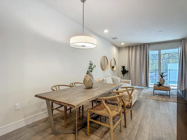 a view of a dining room with a table and chairs