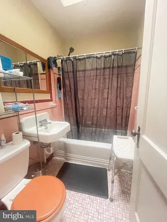 a bathroom with a sink a toilet and bathtub