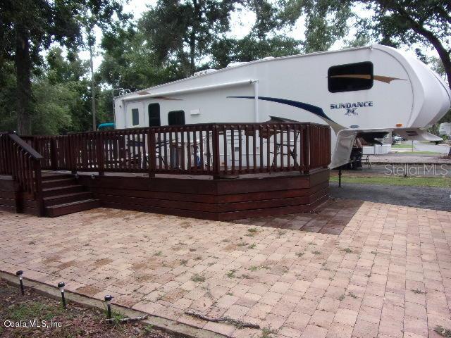 25146 Northeast 140th Loop Salt Springs, FL 32134 - Photo 1 of 1 a view of wooden deck and a yard with swimming pool