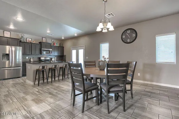 a view of a dining room with furniture wooden floor and a clock