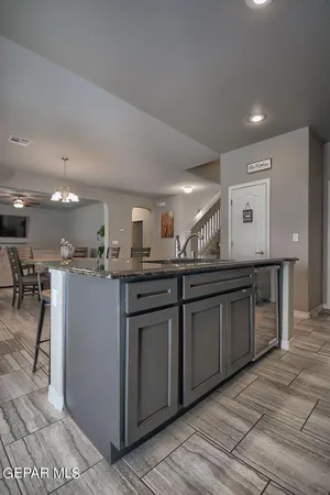 a metallic refrigerator freezer sitting inside of a kitchen