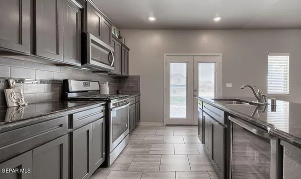 a kitchen with a sink and cabinets