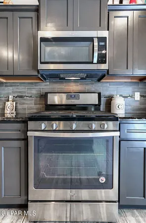 a en suite bathroom with a granite countertop tub and a sink