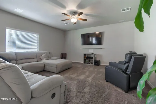 a living room with furniture and a chandelier