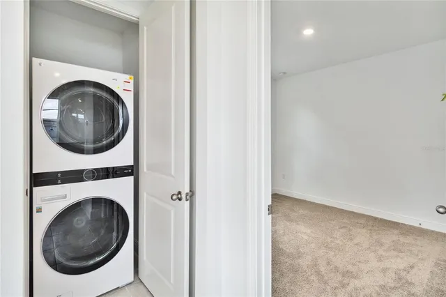 a view of a hallway with washer and dryer