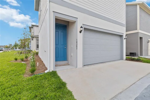 a backyard of a house with a yard and garage
