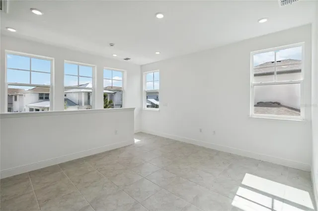 a view of kitchen with kitchen island and windows