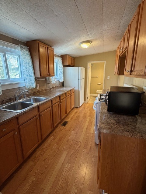 5938 Dunham Road Downers Grove, IL 60516 - Photo 11 of 15 a kitchen with stainless steel appliances granite countertop a sink a stove counter space and cabinets
