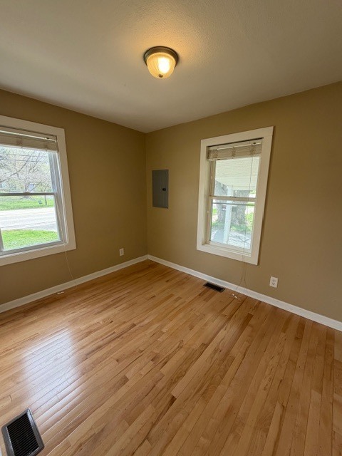5938 Dunham Road Downers Grove, IL 60516 - Photo 7 of 15 a view of an empty room with wooden floor and a window