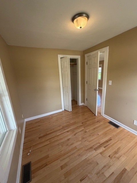 5938 Dunham Road Downers Grove, IL 60516 - Photo 8 of 15 a view of an empty room with wooden floor and a window