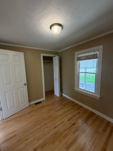 5938 Dunham Road Downers Grove, IL 60516 - Photo 9 of 15 an empty room with wooden floor and windows