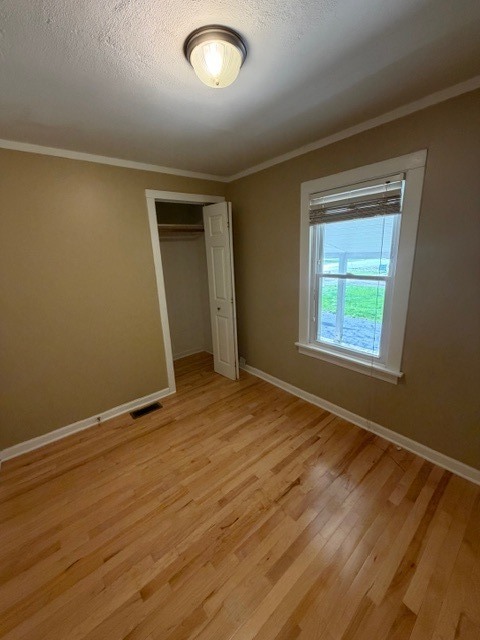 5938 Dunham Road Downers Grove, IL 60516 - Photo 10 of 15 an empty room with wooden floor and windows