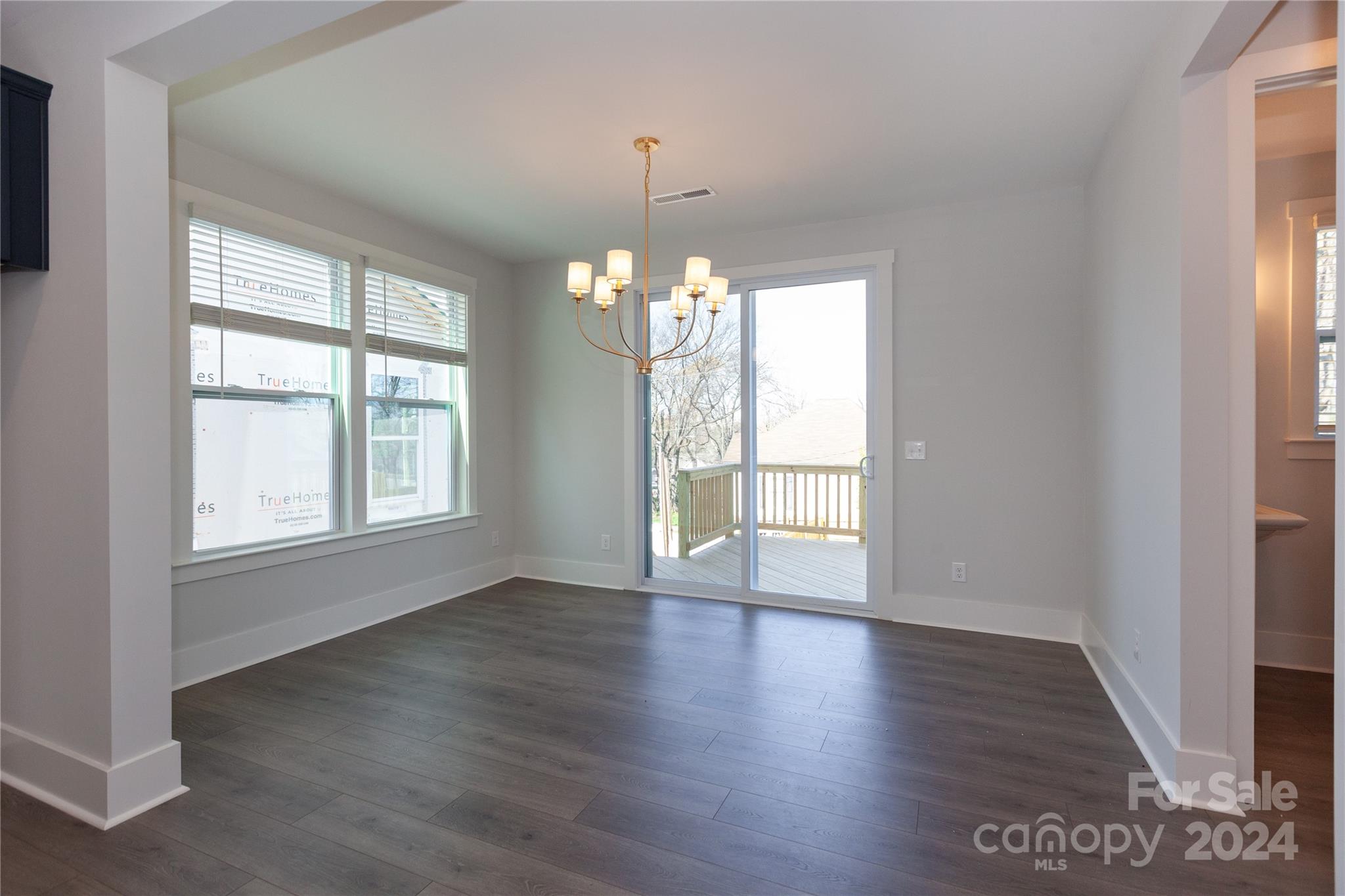 1405 Seigle Avenue Charlotte, NC 28205 - Photo 11 of 35 an empty room with wooden floor and windows