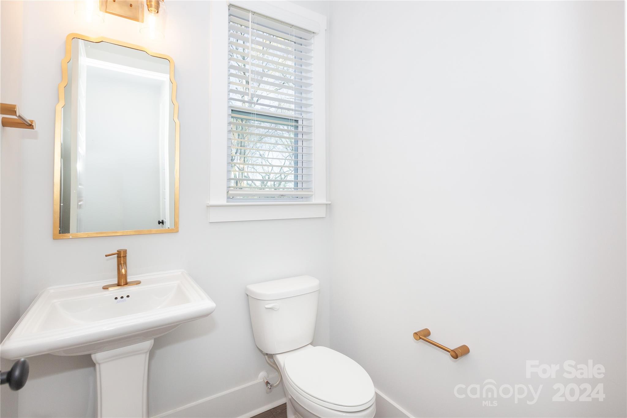 1405 Seigle Avenue Charlotte, NC 28205 - Photo 12 of 35 a bathroom with a sink a toilet and mirror