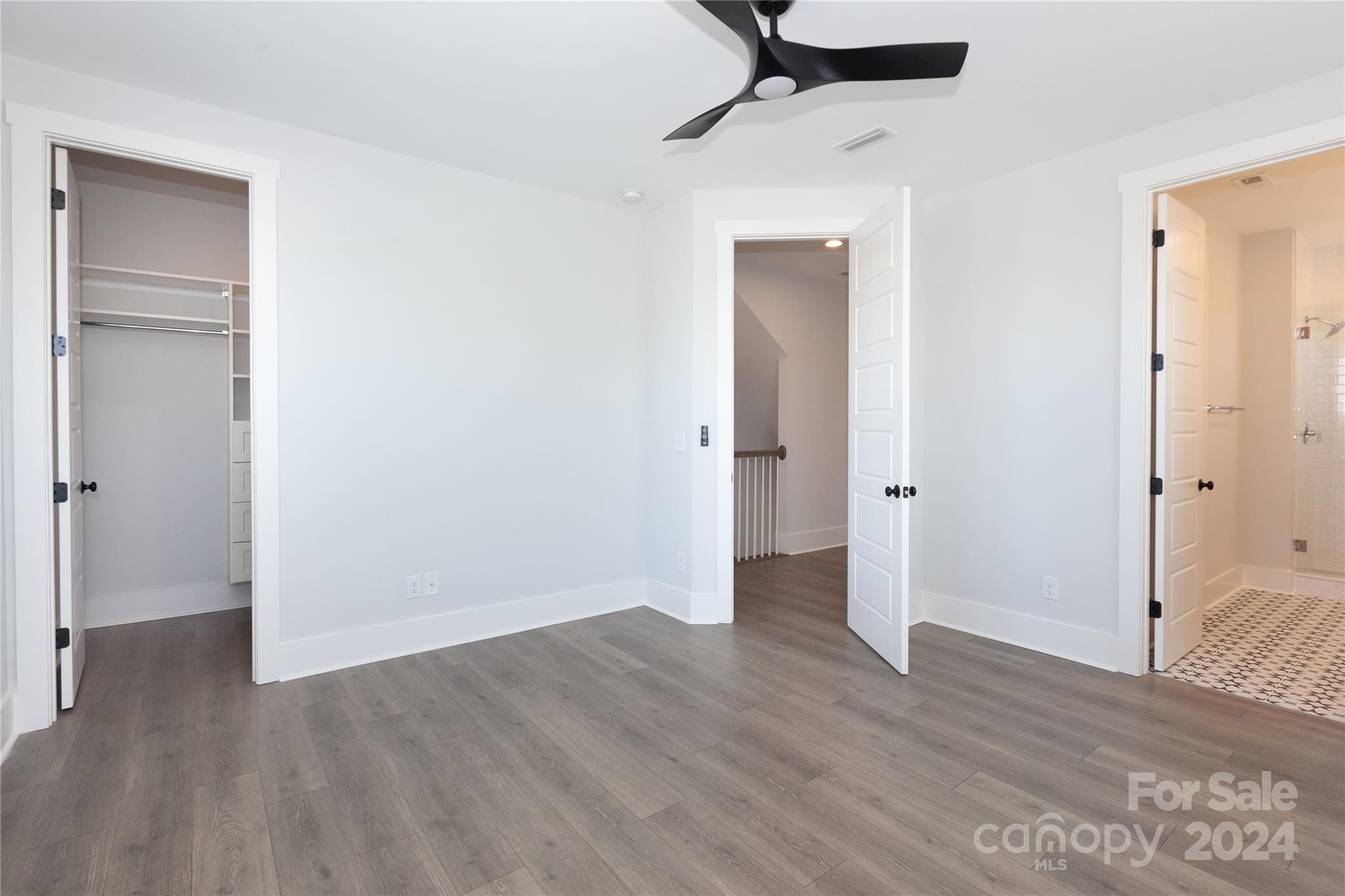 1405 Seigle Avenue Charlotte, NC 28205 - Photo 15 of 35 a view of a room with wooden floor and a ceiling fan