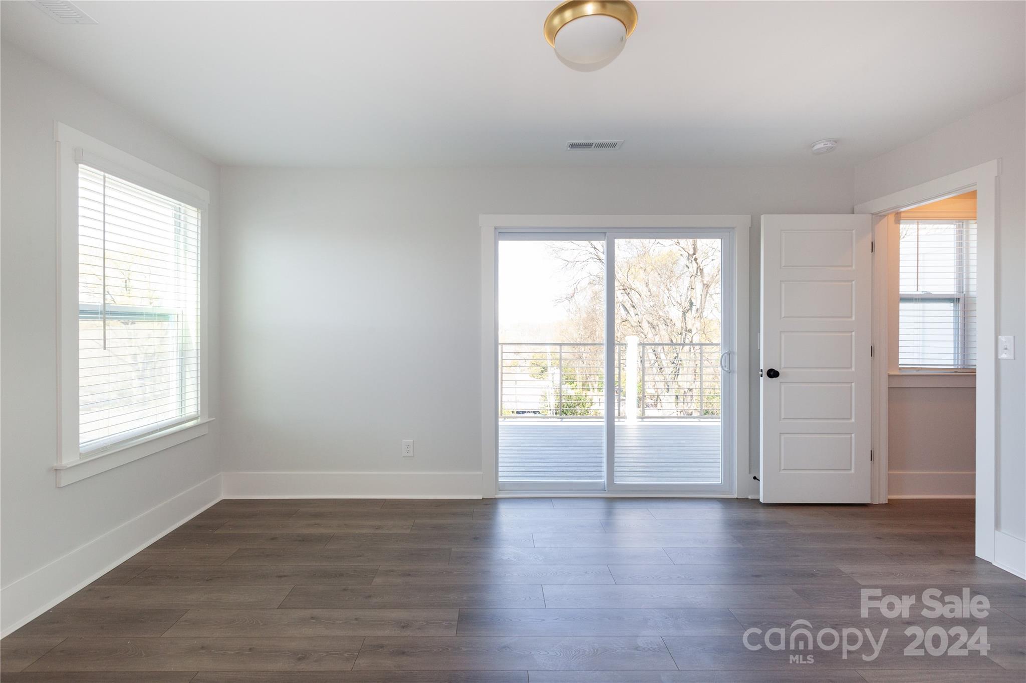 1405 Seigle Avenue Charlotte, NC 28205 - Photo 27 of 35 an empty room with wooden floor and windows