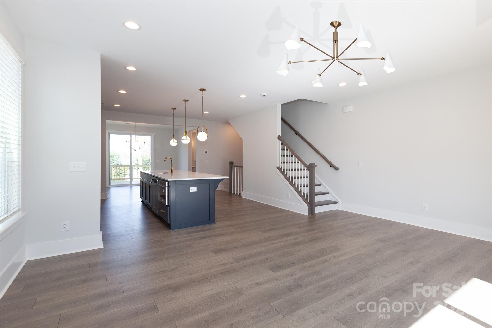 1405 Seigle Avenue Charlotte, NC 28205 - Photo 9 of 35 a view of a room with wooden floor and ceiling fan
