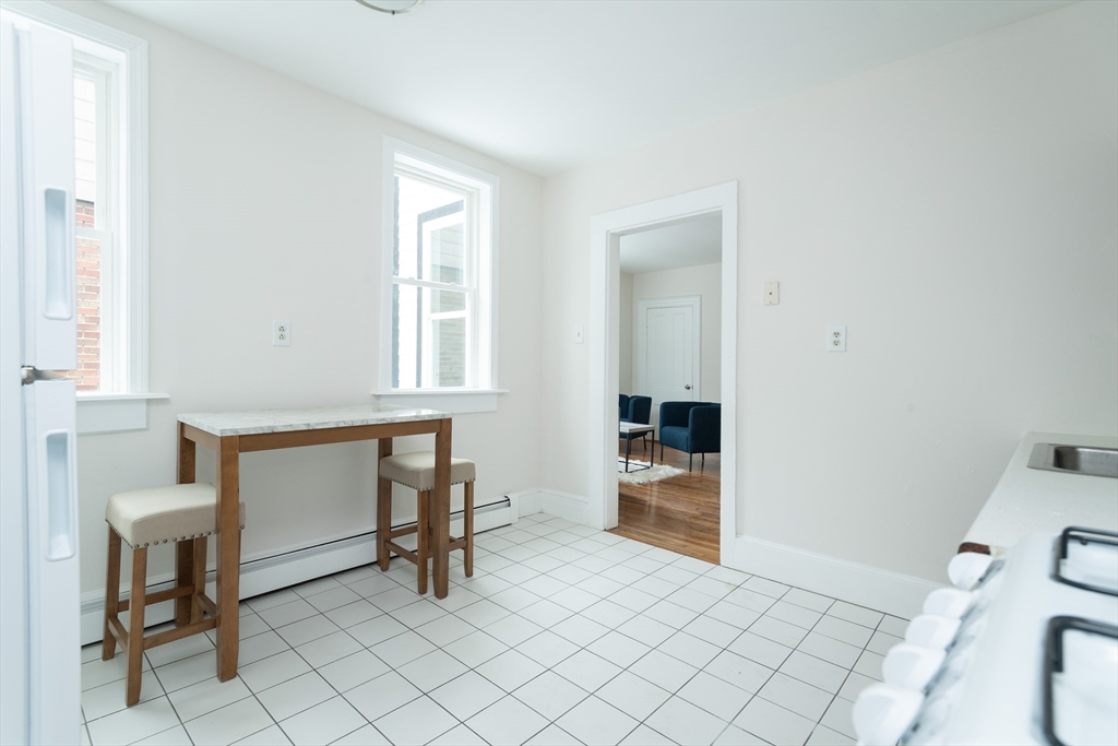 17-19 Spring Garden Street Boston, MA 02125 - Photo 22 of 24 a room that has a bench and a table in it