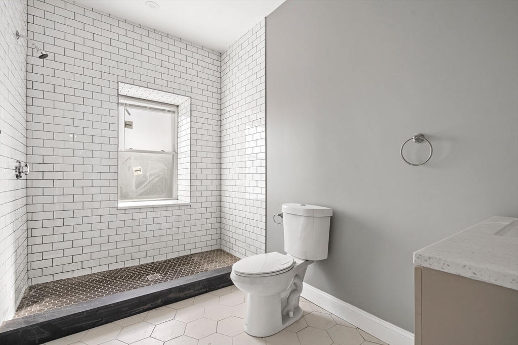 17-19 Spring Garden Street Boston, MA 02125 - Photo 7 of 24 a bathroom with a toilet